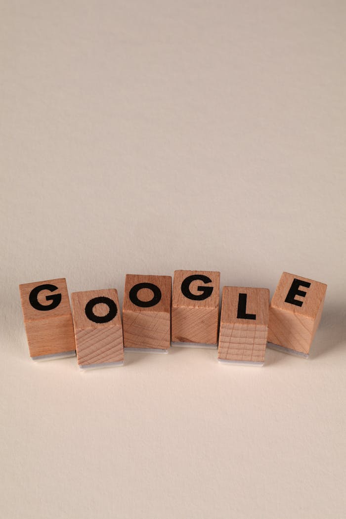 gallery-05 Wooden alphabet blocks forming the word 'Google' on a plain background, arranged playfully.